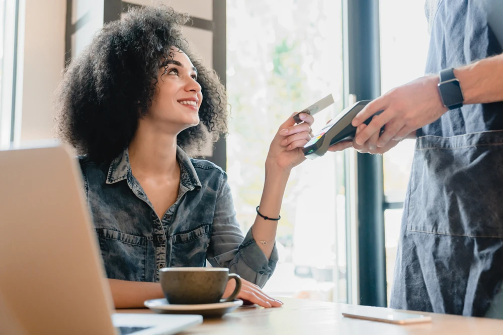 Woman providing credit card for payment