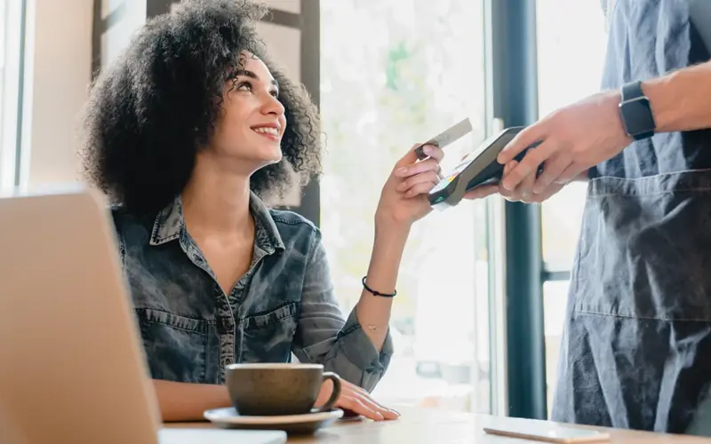 Woman providing credit card for payment