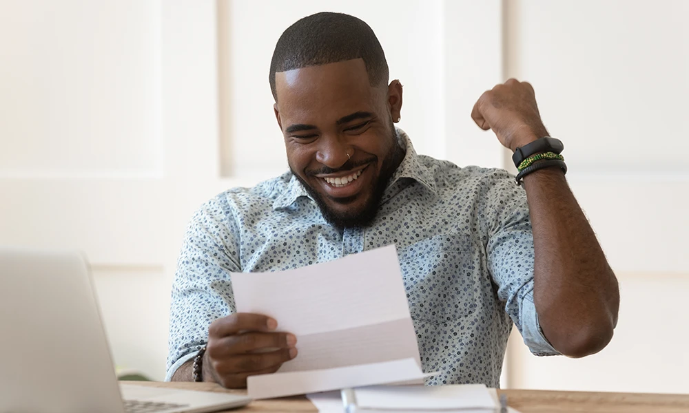 man cheering as he sees his tax refund