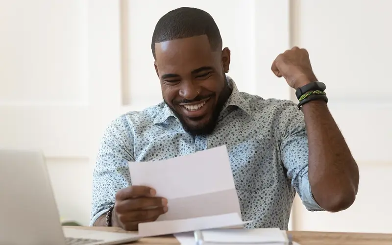 man cheering as he sees his tax refund