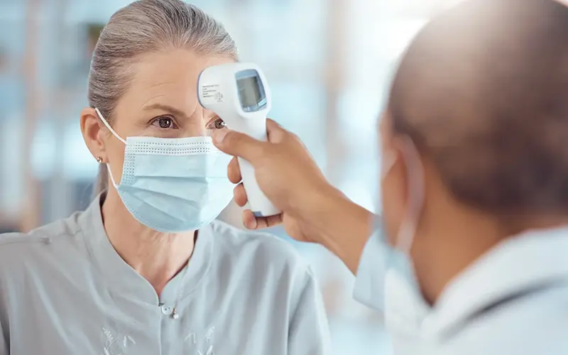 woman getting her temperature taken