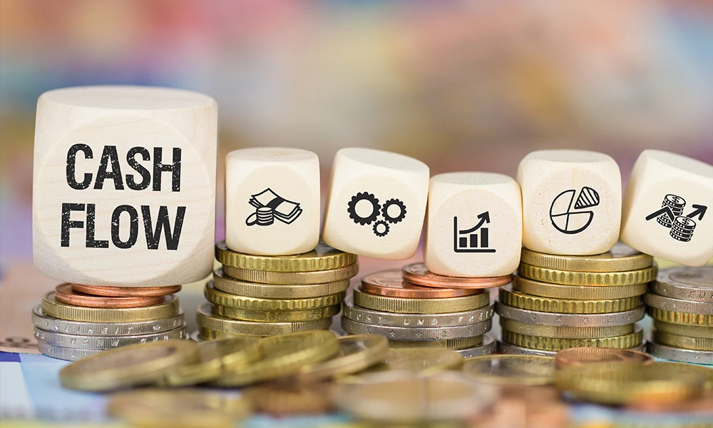 stacks of coins holding dice that each include a financial icon