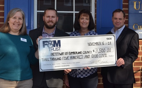 Two F&M Trust employees presenting large check to two United Way of Carlisle and Cumberland County employees.