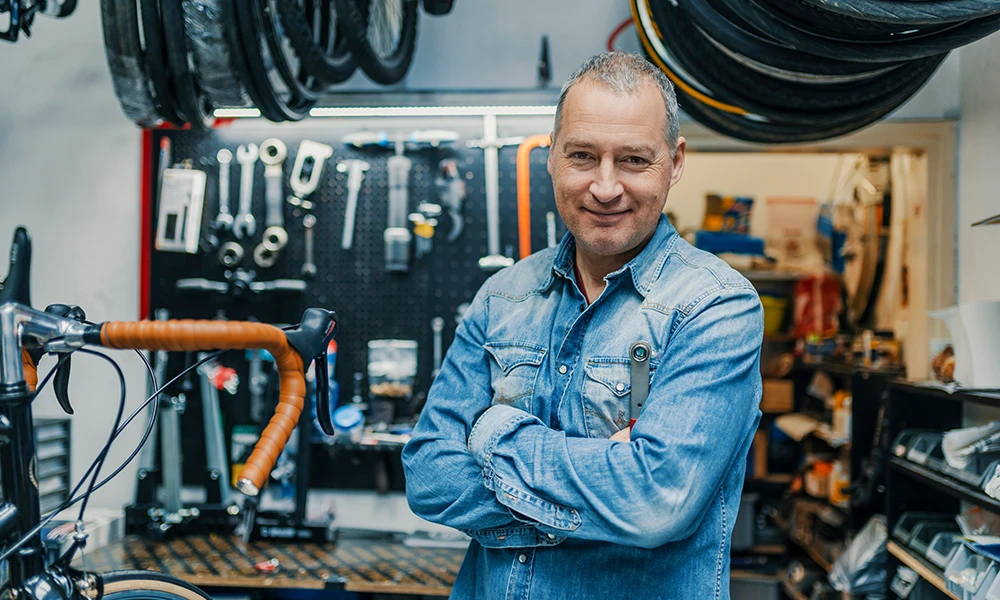 bike mechanic standing in his shop