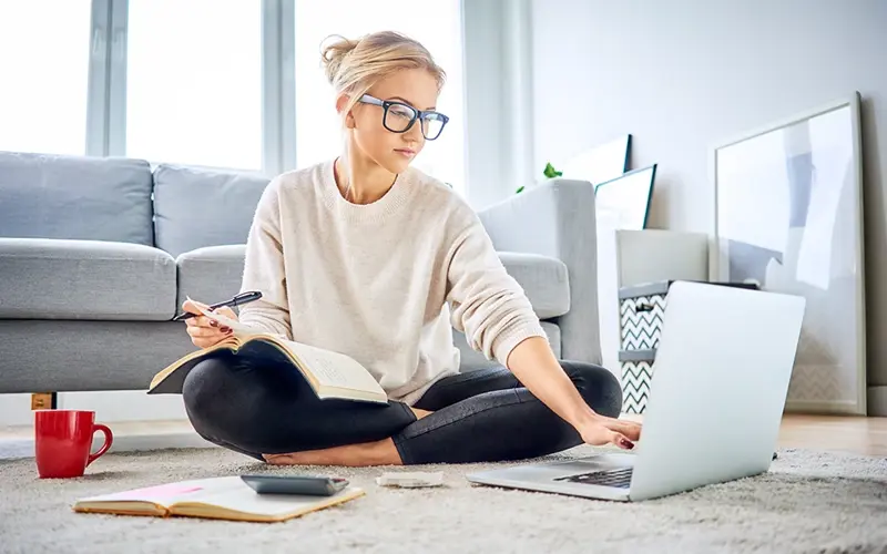 young woman at home balancing her budget