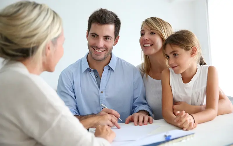 parents with a young daughter speak with an advisor