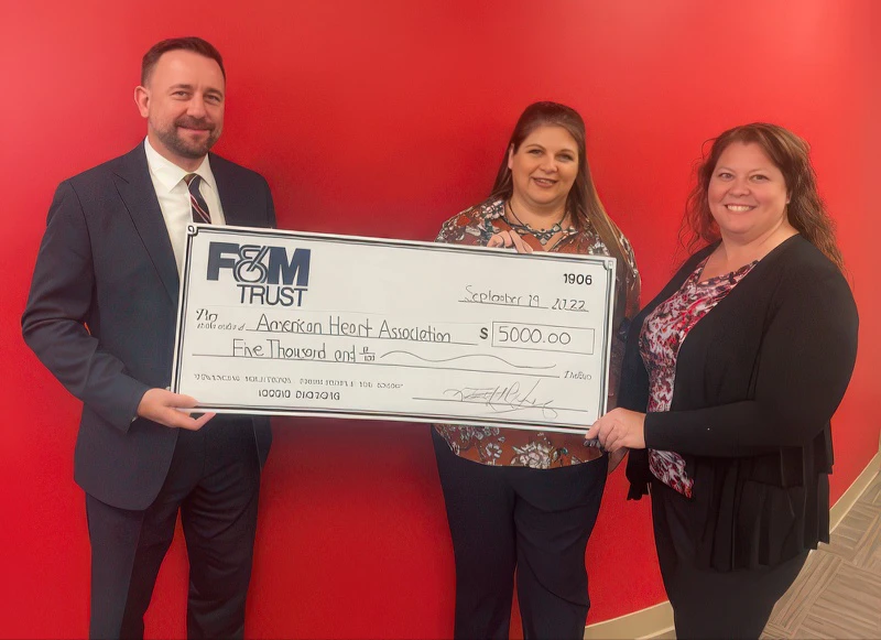 Christian Merritt, F&M Trust Vice President and Investment & Trust Services Market Manager for Cumberland County and the Capital Region, presents a check for $5,000 to Marsha Jackson, Executive Director of the American Heart Association, Capital Region, and Kristie Davis, Development Director of the American Heart Association, Capital Region.