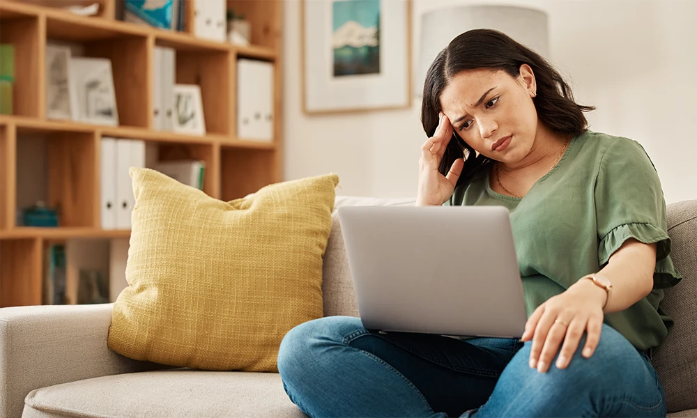 concerned woman looking at her laptop