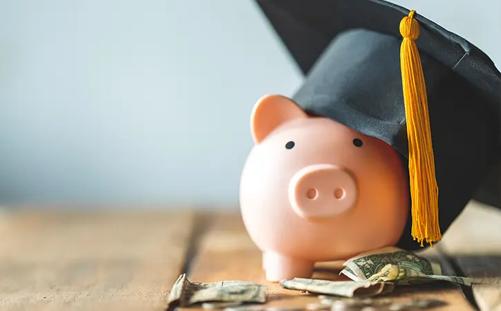 piggy bank wearing a graduation cap