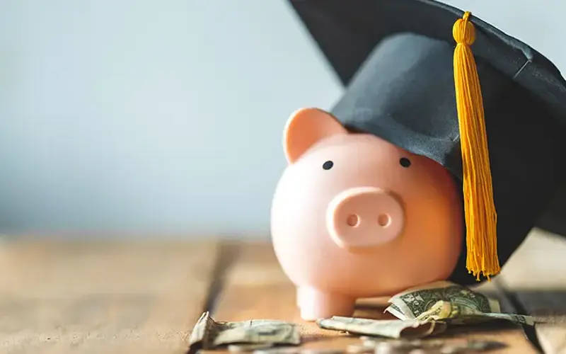 piggy bank wearing a graduation cap