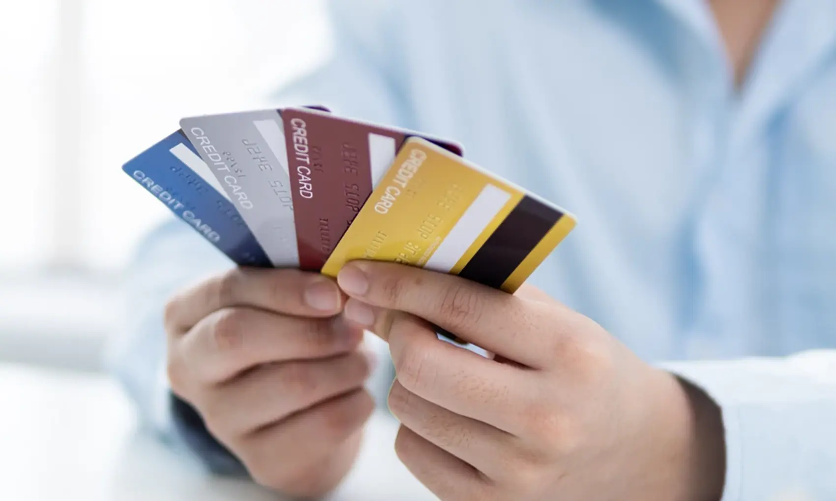 Man holding several credit cards