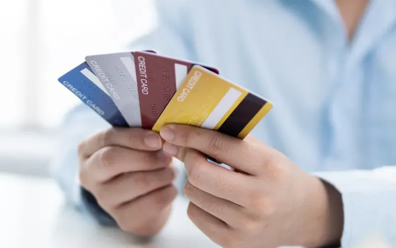 Man holding several credit cards