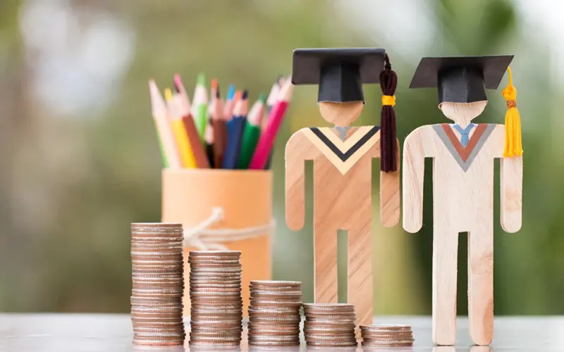 Coins stacked in-front of wood cut outs