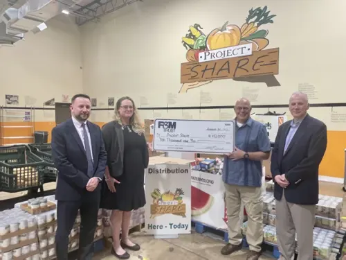 Christian Merritt, Bentley Kirkpatrick, Robert Weed, Andy Klinger holding a large donation check