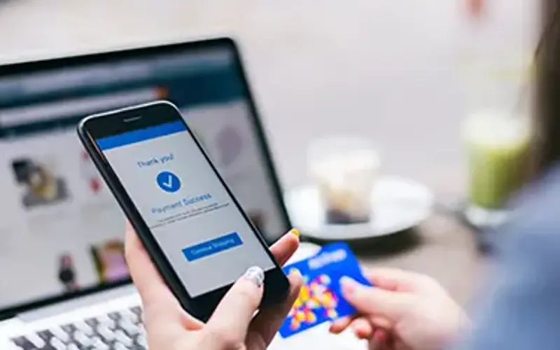 Person using credit card to buy something on their smartphone