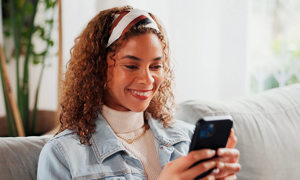 young woman smiling while on her mobile phone