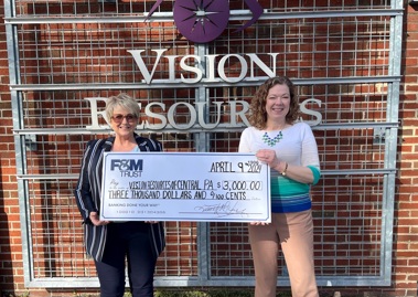 Vision Resources of Central Pennsylvania CEO Cheryl Cuddy accepts a check from Anne Bednar, manager of F&M Trust’s community office in Mechanicsburg.