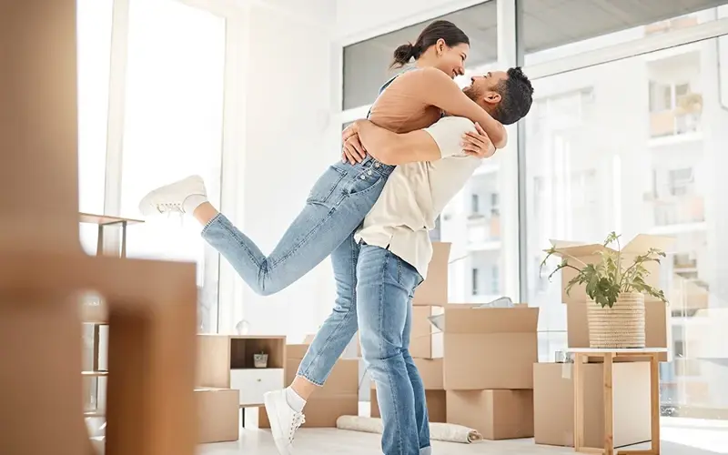 Love, moving and hug with couple in new home for celebration, property and relocation.