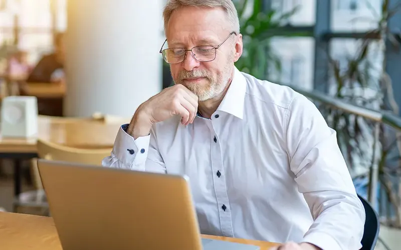 Businessman speaking with colleagues over the laptop