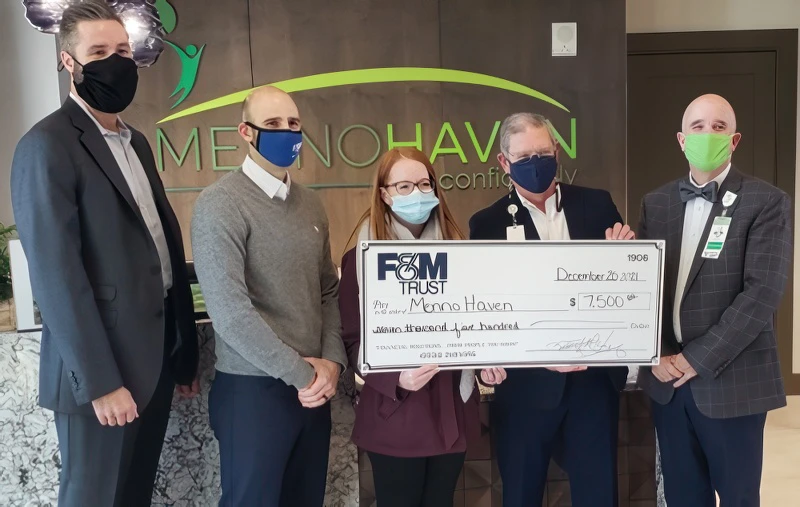 FMT and Menno Haven representatives with large donation check