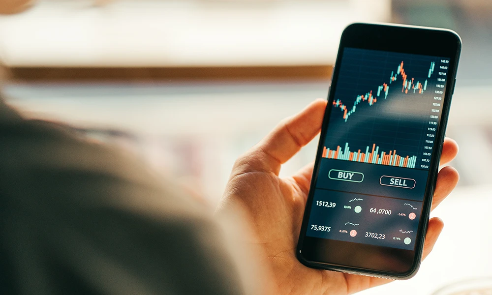 person looking at stocks on mobile phone 