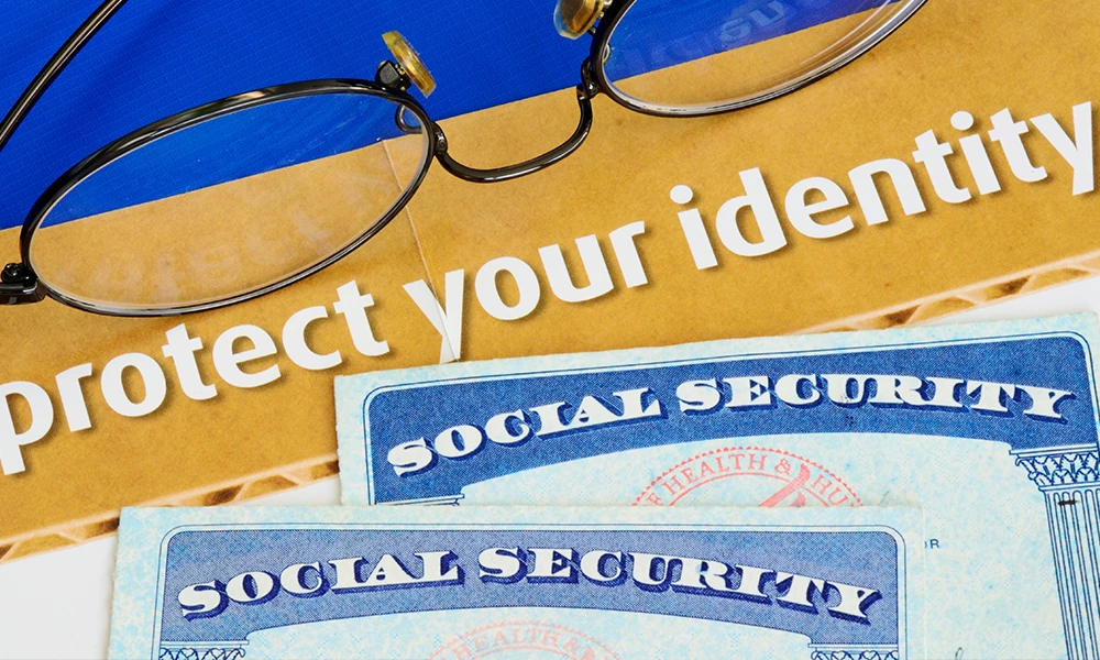 illustration of a pair of glasses, social security cards and the words protect your identity