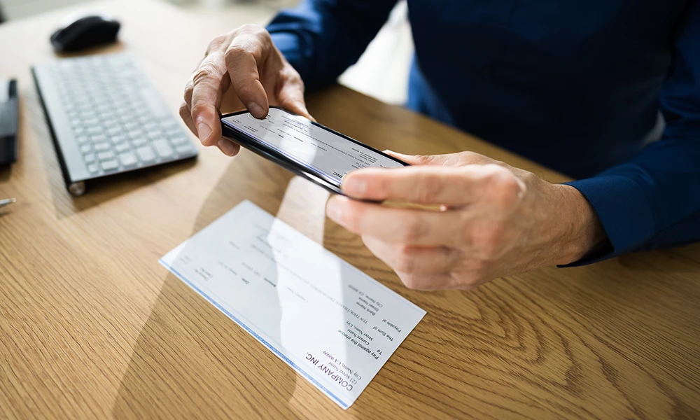 person making a digital deposit of a check using their smartphone