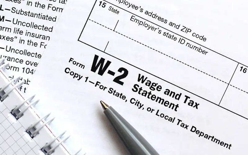 Wage and Tax Statement and a pen