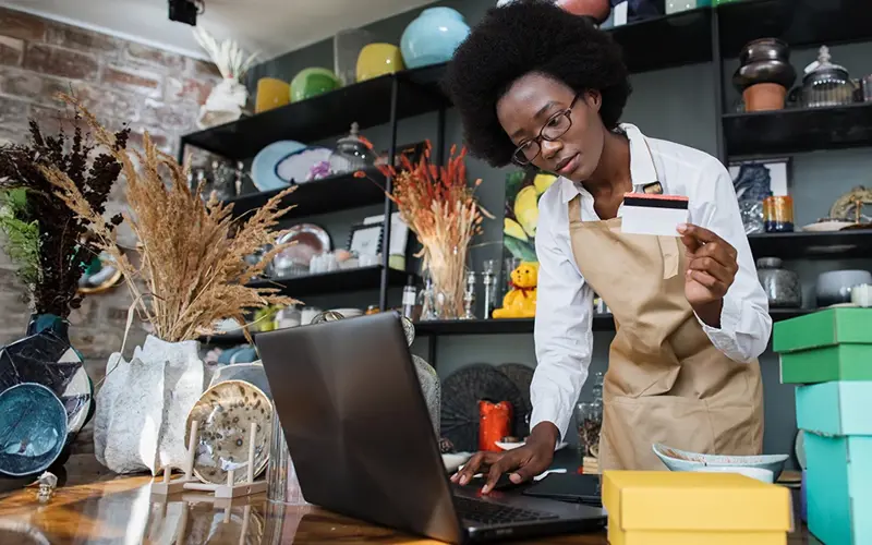 store clerk using credit card to buy merchandise