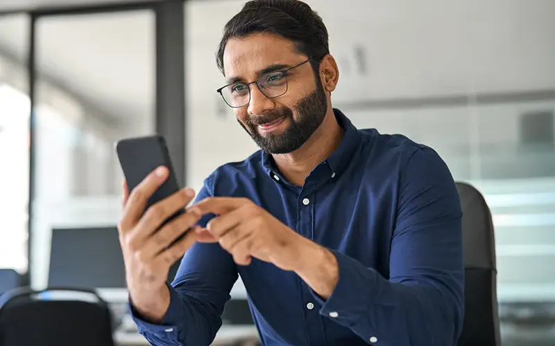 Professional businessman employee looking at smartphone checking banking financial applications