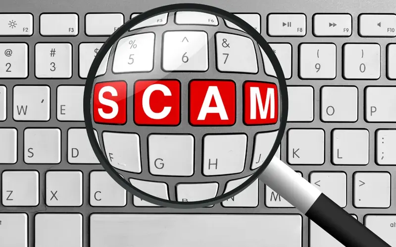 the word scam under a magnify glass