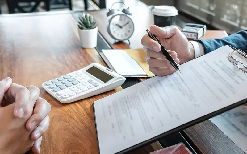 person explaining purchase agreement paperwork