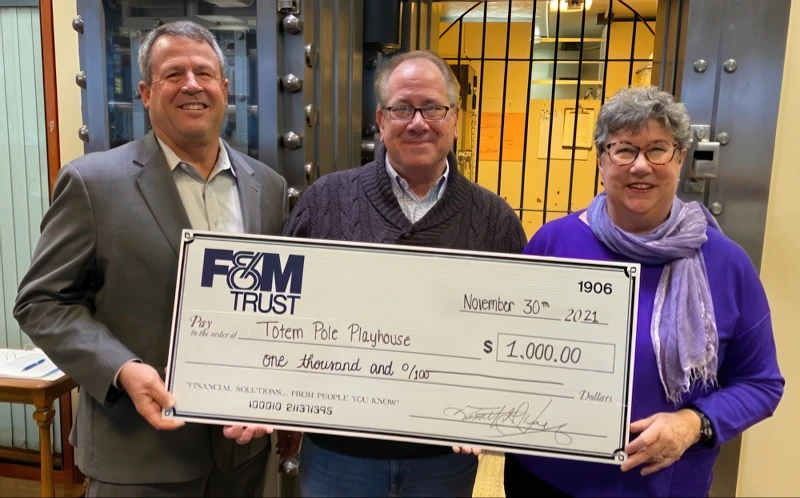 Martha Walker, Tim Henry and David Hemsley pictured with large presentation check