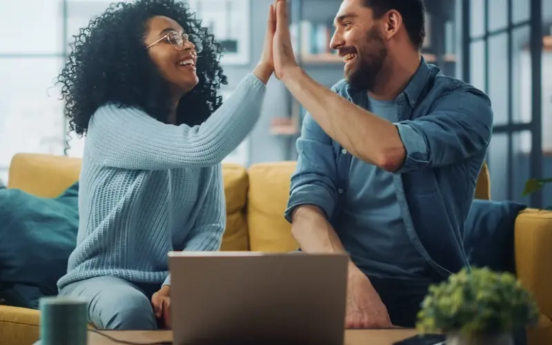 Man Woman On Couch High Fiving