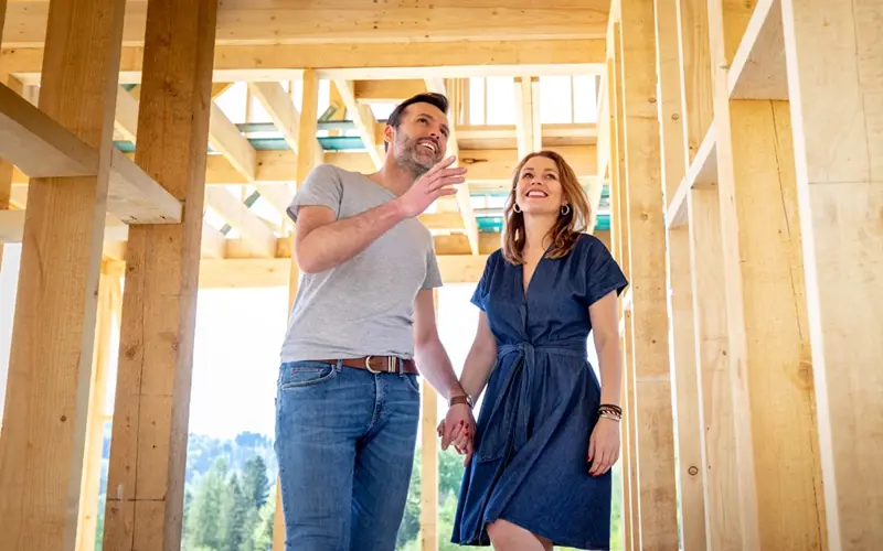 Man and woman touring construction of new home