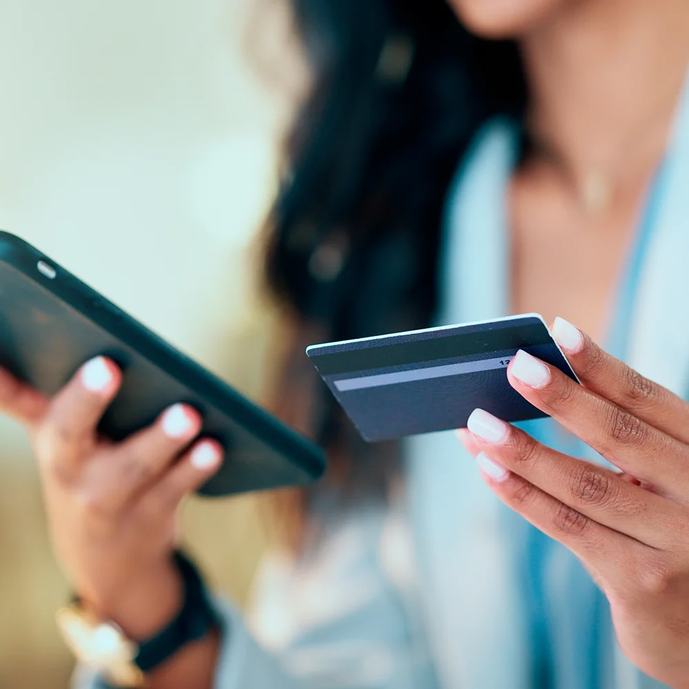 Bank card data put in phone by a lady who does internet banking by typing on her mobile to make an online credit payment